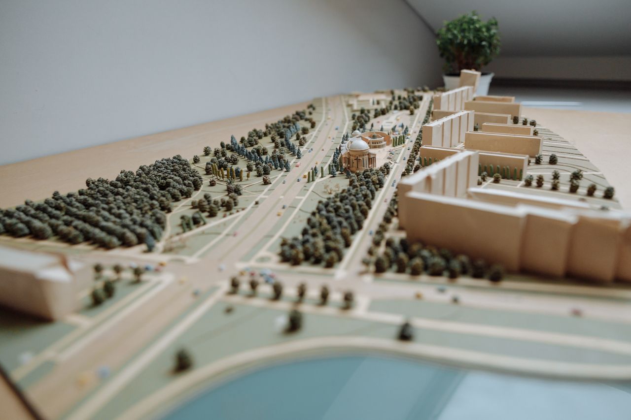 Services Close-up of an architectural miniature model depicting an urban layout with buildings, roads, and greenery.